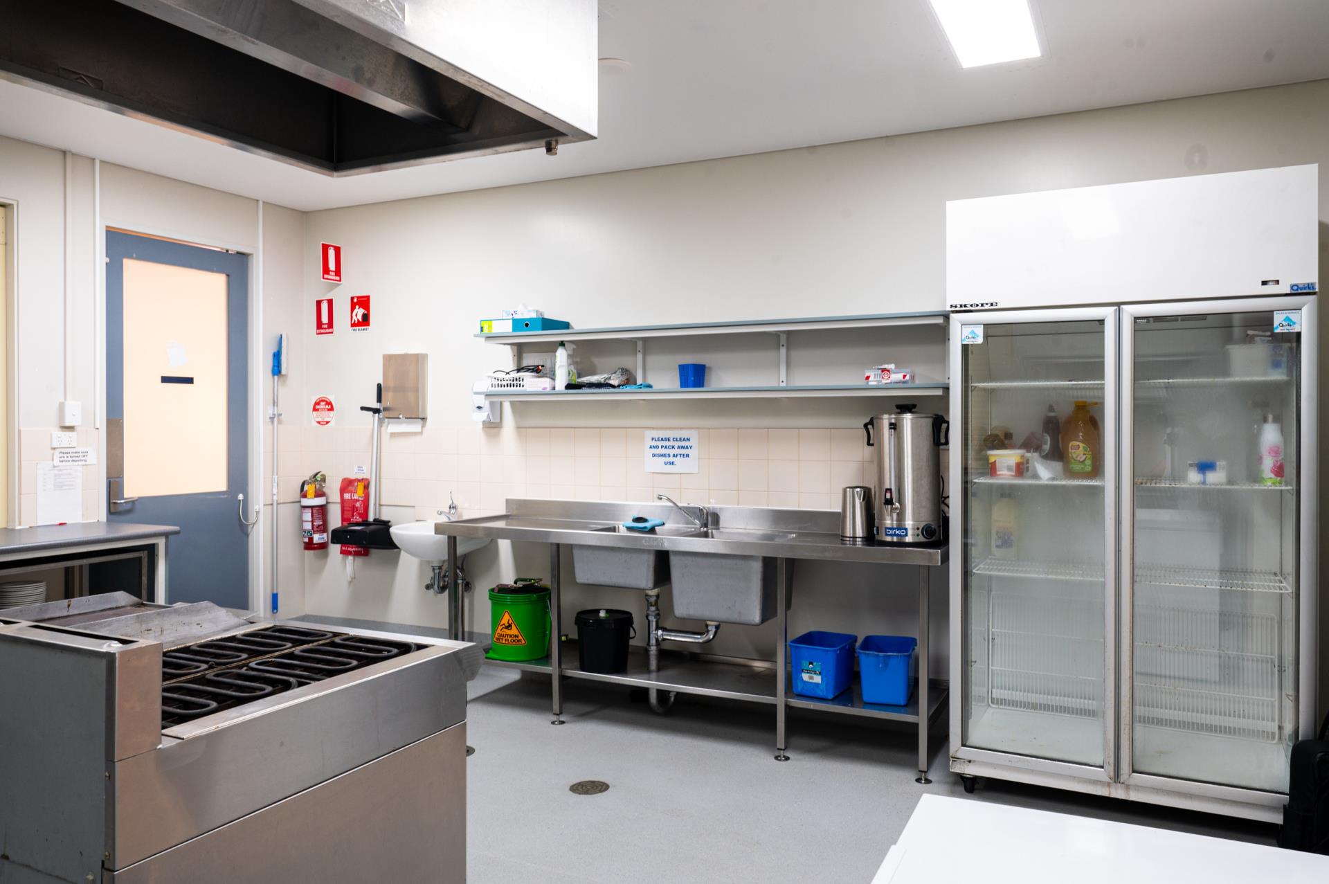 Commercial kitchen with sink and fridge